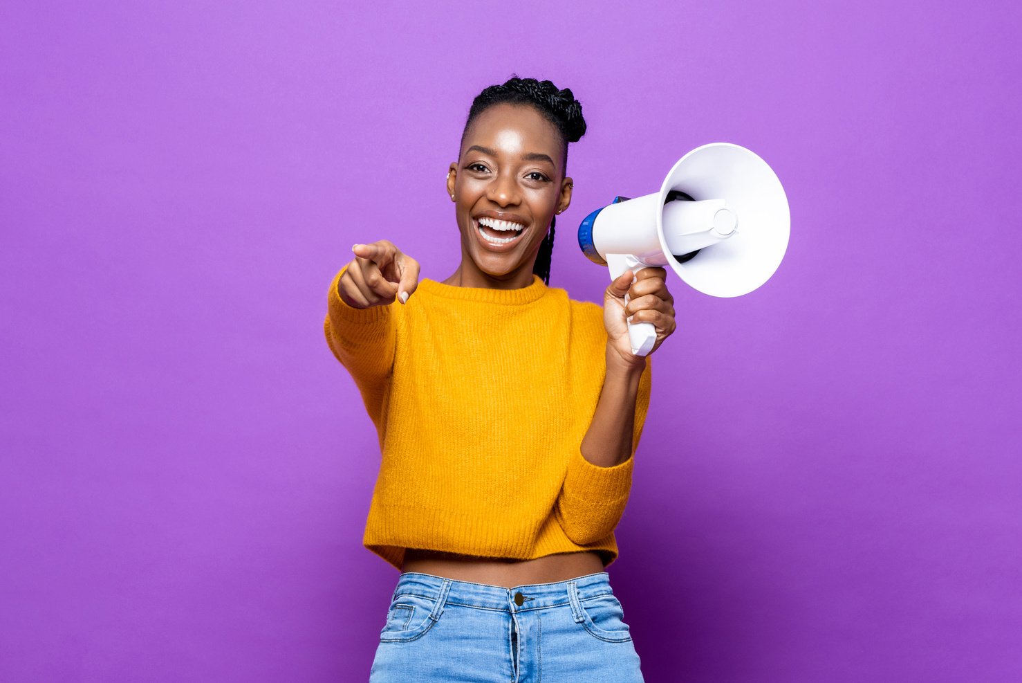 Smiling Woman Pointing and Holding Megaphone